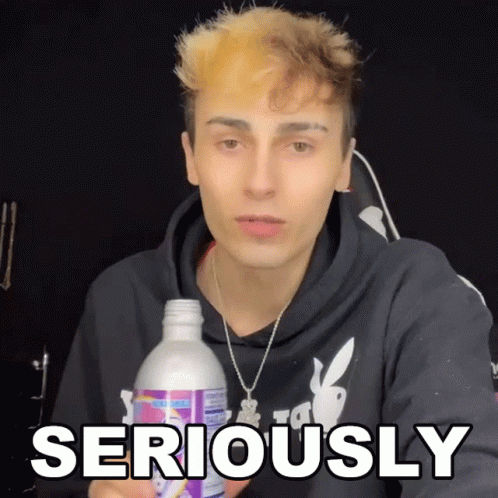 Young Man Holding Bottle Saying Seriously