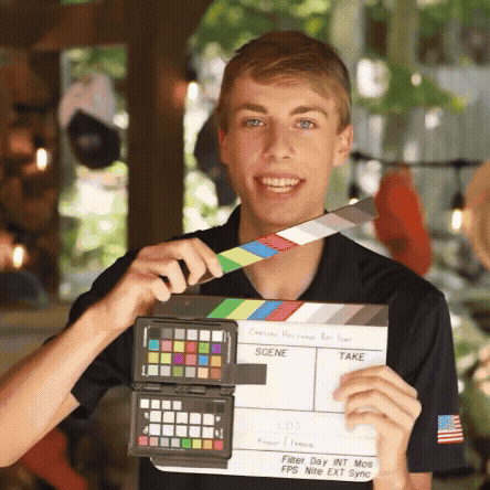 Young Man Holding Clapper Board GIF