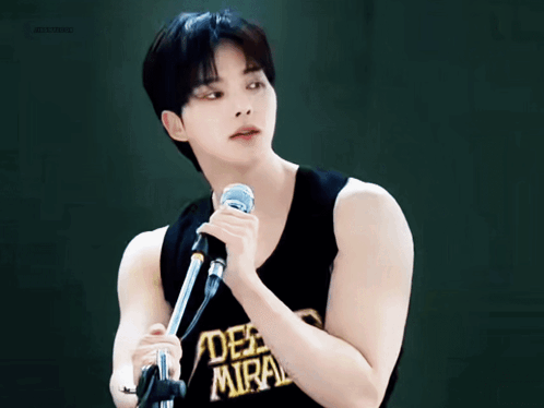 Young Man Holding Microphone Saying Deep Miral