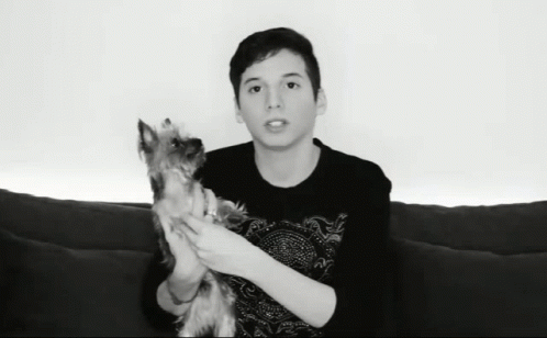 Young Man Holding Small Dog