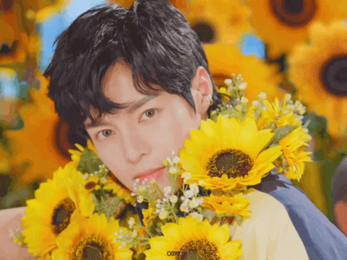 Young Man Holding Sunflowers Saying Osr GIF