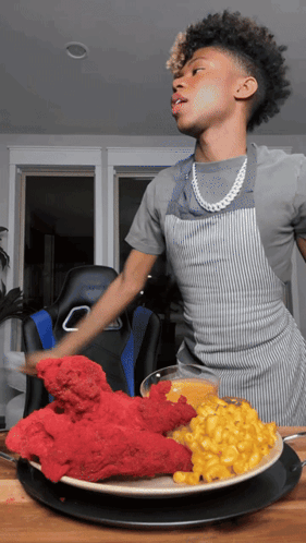Young Man In Apron With Plate Of Food GIF