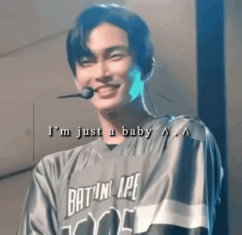 Young Man in Baseball Jersey Smiling With Microphone