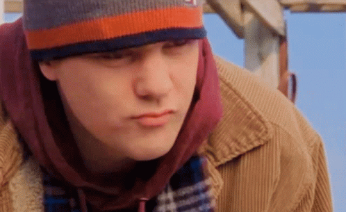 Young Man in Beanie and Plaid Scarf