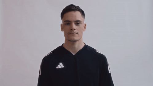 Young Man in Black Adidas Shirt Making Funny Face