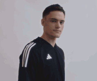 Young Man in Black Adidas T-Shirt Arms Crossed