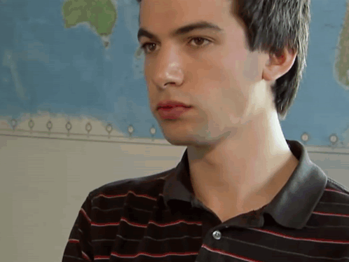 Young Man in Black and Red Striped Shirt by World Map