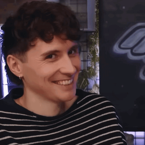 Young Man in Black and White Striped Sweater Smiling