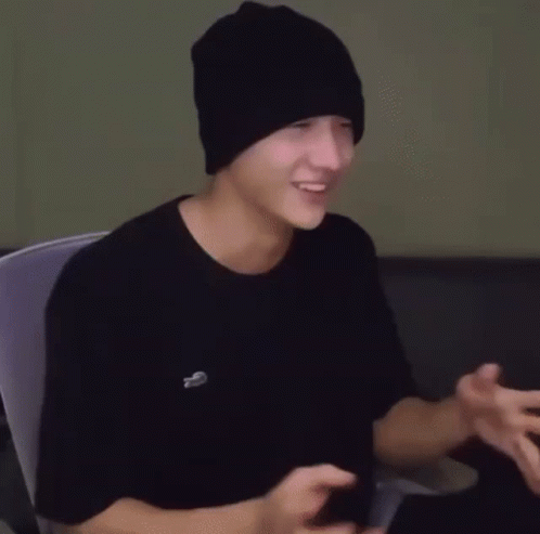 Young Man in Black Beanie and T-Shirt Sitting