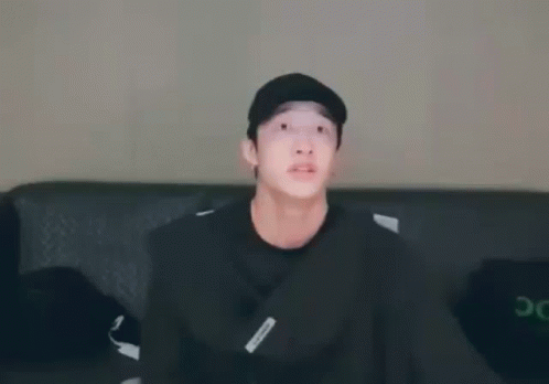 Young Man in Black Hat Sitting on Couch
