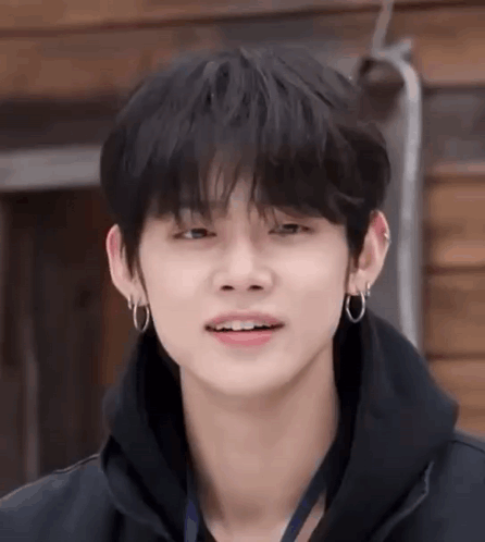 Young Man in Black Hoodie and Earrings