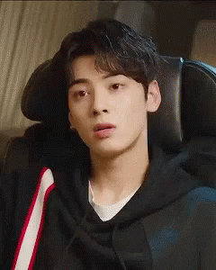 Young Man in Black Hoodie Sitting in Chair