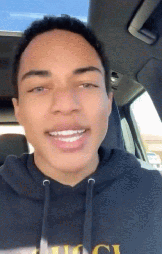 Young Man In Black Hoodie Smiling In Car GIF