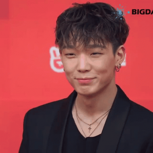 Young Man In Black Jacket And Cross Necklace Smiling GIF