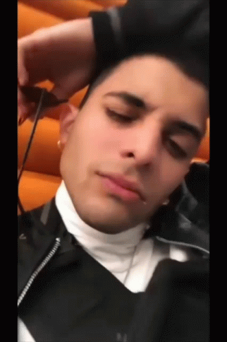 Young Man in Black Jacket Resting Head