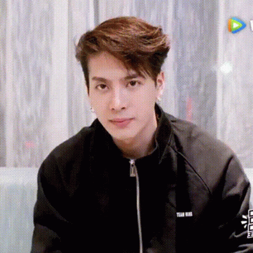 Young Man in Black Jacket Sitting on Couch