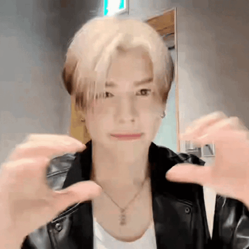 Young Man in Black Leather Jacket Making Heart With Hands