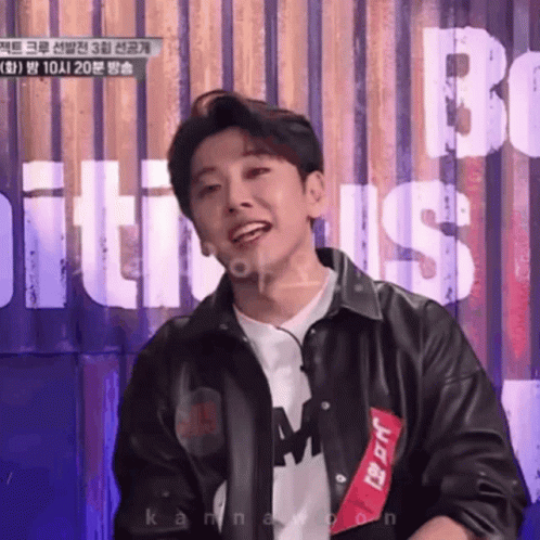 Young Man In Black Leather Jacket Smiling At Be Sign GIF