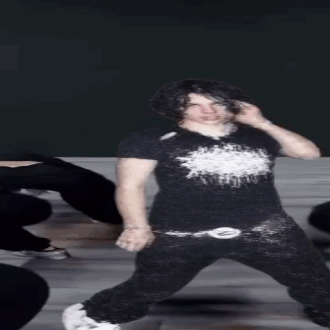 Young Man in Black Shirt and Black Pants