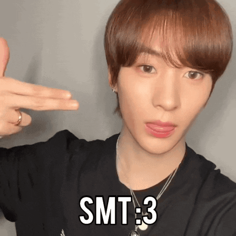 Young Man in Black Shirt and Necklace With SMT 3 on Forehead