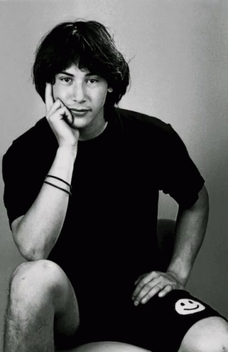 Young Man in Black Shirt and Shorts With Smiley Face