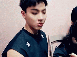 Young Man In Black Shirt Eating GIF