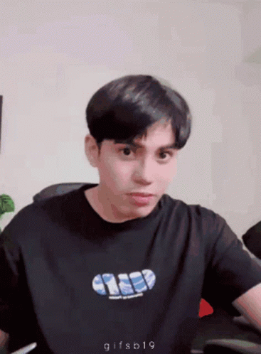 Young Man in Black Shirt Saying Gifsb19 Looking at Camera