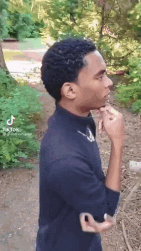 Young Man in Black Shirt Smoking Cigarette