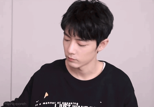 Young Man in Black Shirt With Chinese Writing Making a Face