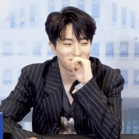 Young Man in Black Striped Suit Sitting
