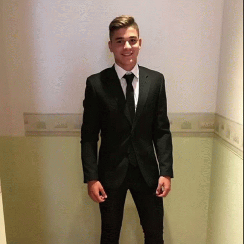 Young Man In Black Suit And Tie Hallway GIF