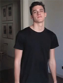 Young Man In Black T-Shirt With Arms Outstretched GIF