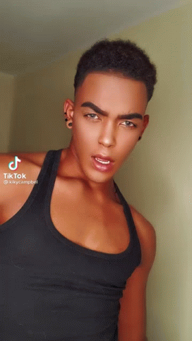 Young Man in Black Tank Top and Earrings