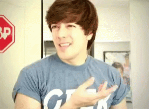 Young Man In Blue Geek Shirt At Stop Sign GIF