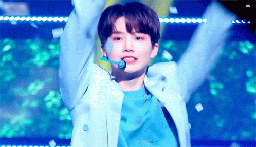 Young Man in Blue Jacket Arms Up Confetti