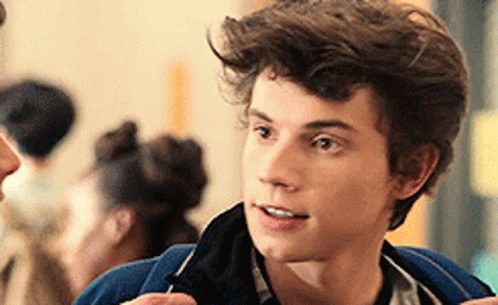Young Man in Blue Jacket Talking to Woman