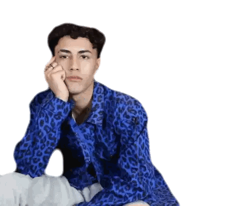 Young Man in Blue Leopard Shirt Hand on Face