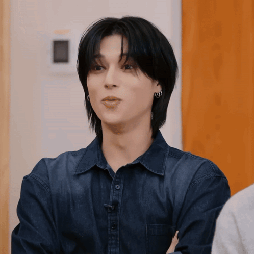 Young Man In Blue Shirt And Earrings Staring GIF