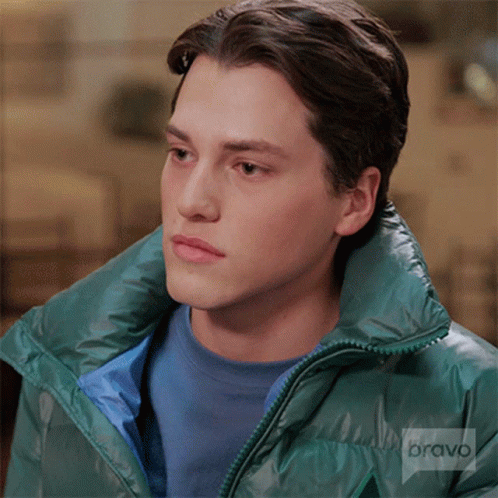 Young Man in Blue Shirt and Green Jacket with Bravo