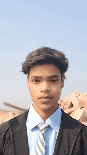 Young Man in Blue Shirt and Tie with TMC Bricks