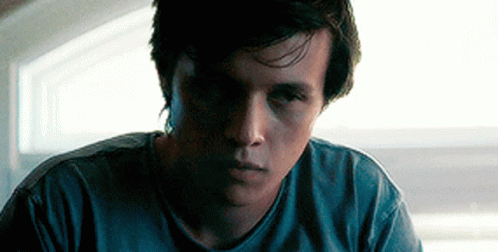 Young Man in Blue Shirt Looking at Camera