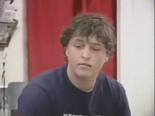 Young Man In Blue Shirt With Letter T GIF