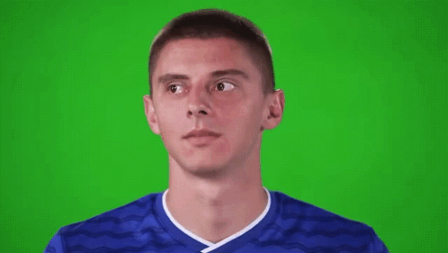 Young Man in Blue Soccer Jersey Looking Up on Green Screen