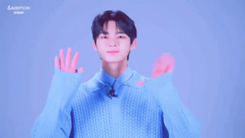Young Man in Blue Sweater Making Funny Face