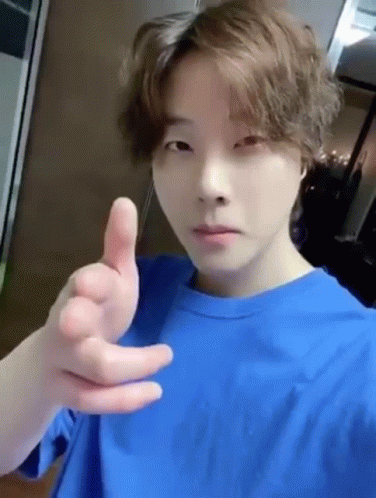 Young Man in Blue T-Shirt Giving Thumbs Up