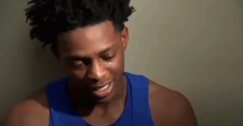 Young Man in Blue Tank Top Crying