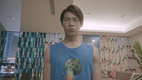 Young Man in Blue Tank Top With Cartoon Character
