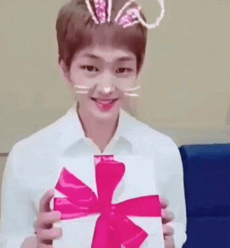 Young Man in Bunny Ears Holding White Box with Pink Bow