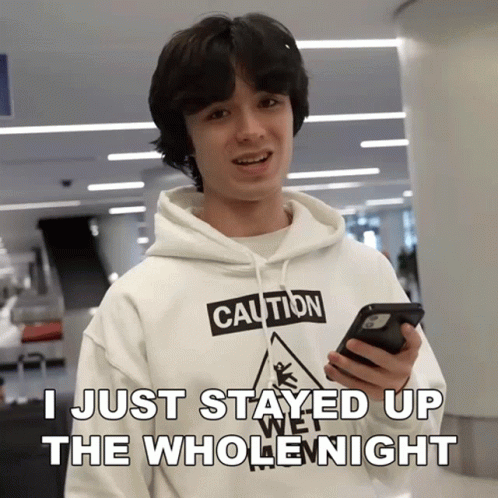 Young Man in Caution Hoodie Holding Phone