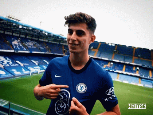 Young Man in Chelsea Jersey Pointing at Chest